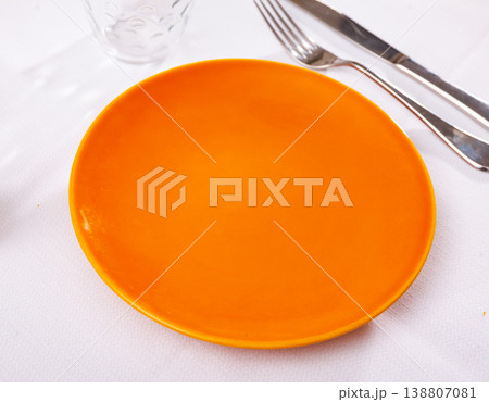 Empty plate and serving pieces on table Empty plate and serving pieces on table 138807081