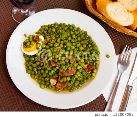 Just cooked green peas with ham and egg on plate Just cooked green peas with ham and egg on plate 138807088