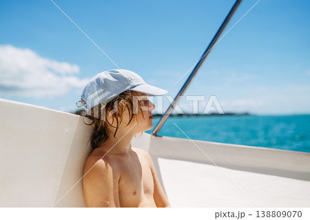 Child relaxing on boat during tropical family vacation. 138809070
