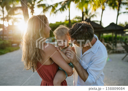 Parents with little toddler in tropical beach resort. Parents with little toddler in tropical beach resort. 138809084