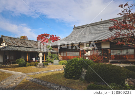Nov 24 2025 Zen temple main hall framed by seasonal garden windows 138809222