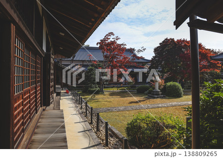 Nov 24 2025 Zen temple main hall framed by seasonal garden windows 138809265