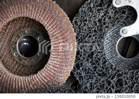 Close-up of abrasive and stripping discs for angle grinder on a dark background Close-up of abrasive and stripping discs for angle grinder on a dark background 138810850