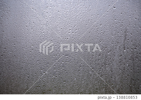 Closeup Of Water Droplets And Condensation On Glass Window With Gray Textured Surface Closeup Of Water Droplets And Condensation On Glass Window With Gray Textured Surface 138810853
