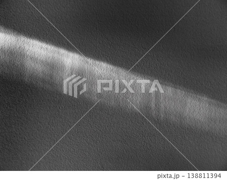A ray of sunlight on a white plaster wall. The texture is an abstraction. A ray of sunlight on a white plaster wall. The texture is an abstraction. 138811394