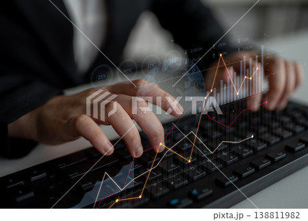 Business Person Analyzing Data with Charts on a Computer Keyboard for Financial Growth in Modern Workspace Environment Scalp Business Person Analyzing Data with Charts on a Computer Keyboard for Financial Growth in Modern Workspace Environment Scalp 138811982