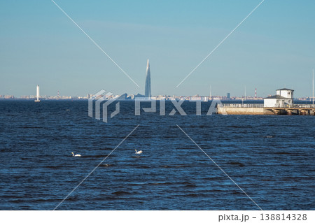 Clear blue sky overlooks calm water. Lakhta Center in St. Petersburg 138814328