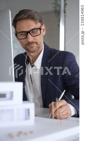 Architect developing building blueprint on computer, engineering and urban planning a new construction project. Business and architecture concept Architect developing building blueprint on computer, engineering and urban planning a new construction project. Business and architecture concept 138814965
