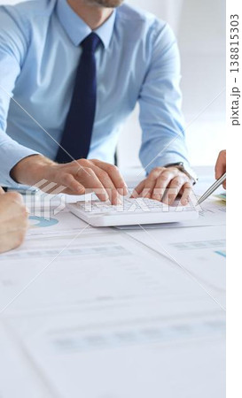 Business people team meeting with charts and documents on desk discussing financial strategy, planning corporate growth, analyzing market data and performance reports Business people team meeting with charts and documents on desk discussing financial strategy, planning corporate growth, analyzing market data and performance reports 138815303