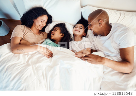 Top view, bed and family with love, laughing and funny happiness, bonding and loving together. Parents, mother or father with children, kids and cheerful in a bedroom, humor and quality time with joy Top view, bed and family with love, laughing and funny happiness, bonding and loving together. Parents, mother or father with children, kids and cheerful in a bedroom, humor and quality time with joy 138815548