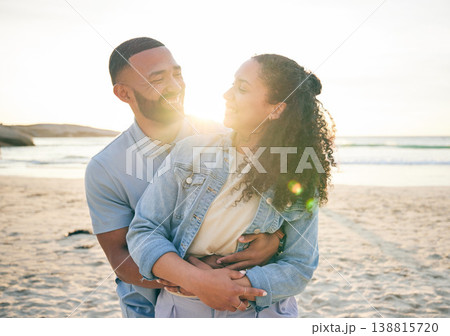 Hug, beach and couple with love, vacation and marriage with happiness, summer holiday and relax. Romance, happy man and woman embrace, seaside and lens flare with relationship, sunset and adventure 138815720