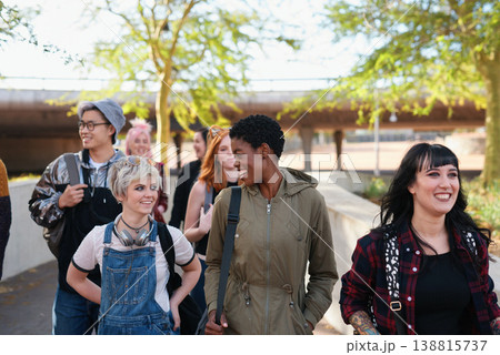College, campus and group of students walking at university talking and speaking with diversity ready for learning. Happy, education and young gen z people or friends with a scholarship together College, campus and group of students walking at university talking and speaking with diversity ready for learning. Happy, education and young gen z people or friends with a scholarship together 138815737