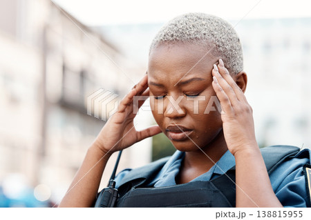 Black woman, police and headache in stress, anxiety or burnout in the city for justice or law enforcement. Tired female person or officer in pain, depression or overworked in street of an urban town 138815955