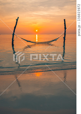 Stunning tropical sunset hammock over calm ocean warm golden sunlight horizon peaceful summer vacation travel scenic beach landscape Stunning tropical sunset hammock over calm ocean warm golden sunlight horizon peaceful summer vacation travel scenic beach landscape 138815972