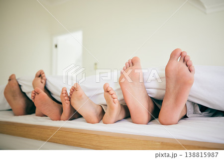 Feet, sleep and family in a bed relax, resting and enjoying a weekend nap in their home. Sleeping, foot and children with parents in bedroom for dreaming, stress relief or vacation freedom in a house Feet, sleep and family in a bed relax, resting and enjoying a weekend nap in their home. Sleeping, foot and children with parents in bedroom for dreaming, stress relief or vacation freedom in a house 138815987