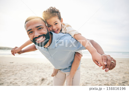 Father, son and piggyback, beach and portrait with love and bonding, travel and ocean with holiday, fun and happiness. Playful, smile and trust, man and boy together with vacation and sea adventure Father, son and piggyback, beach and portrait with love and bonding, travel and ocean with holiday, fun and happiness. Playful, smile and trust, man and boy together with vacation and sea adventure 138816196