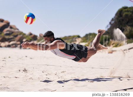 Beach, energy and man jump volleyball while playing on the sand with action on holiday. Fitness person, sports ball and young male athlete training for seaside game or match in summer by the ocean. Beach, energy and man jump volleyball while playing on the sand with action on holiday. Fitness person, sports ball and young male athlete training for seaside game or match in summer by the ocean. 138816269