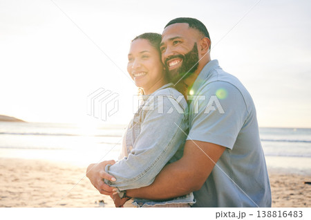Hug, beach and couple with love, sunset and marriage with happiness, summer holiday and relationship. Romance, happy man and woman embrace, seaside vacation and relationship with a smile and travel 138816483