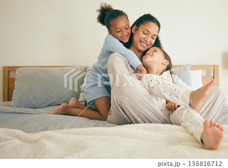 Mother, bed and children hug or happy with parent together in the morning laughing in a bedroom in a home. Funny, bonding and mom enjoy quality time with kids or girls with happiness and love Mother, bed and children hug or happy with parent together in the morning laughing in a bedroom in a home. Funny, bonding and mom enjoy quality time with kids or girls with happiness and love 138816712