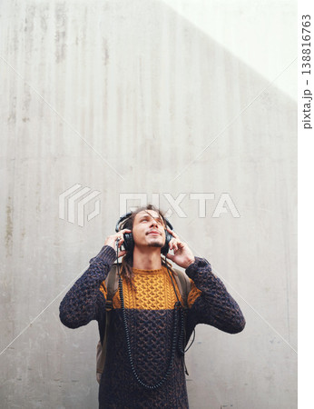 Man is listening to music, student with headphones on university campus and future mindset against wall background. Gen z, education and male person at college, mockup space and podcast streaming 138816763