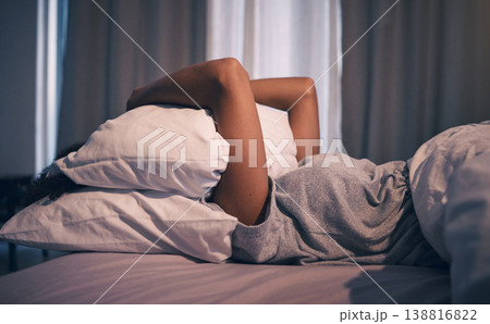 Sleep, insomnia and woman with pillow on face, tired and frustrated with stress, nightmare or dream in bedroom. Fatigue, sleeping problem and girl in bed with fear, scared at night and crisis in home 138816822