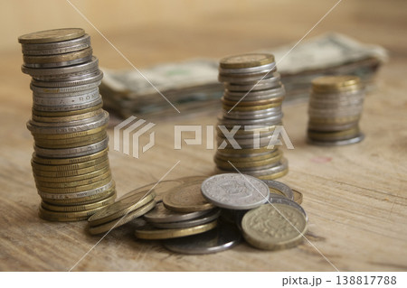 Stacks of international coins and banknotes on wooden table for finance Stacks of international coins and banknotes on wooden table for finance 138817788