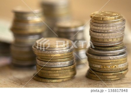 Stacks of international coins and banknotes on wooden table for finance 138817848