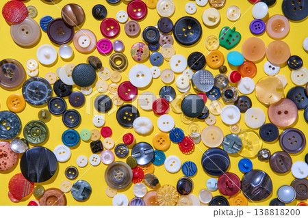 Colorful sewing buttons on bright yellow background 138818200