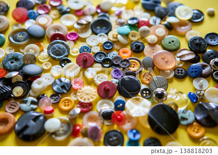 Colorful sewing buttons on bright yellow background 138818203