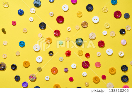 Colorful sewing buttons on bright yellow background 138818206