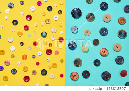 Assorted sewing buttons on yellow and blue background 138818207