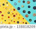 Assorted sewing buttons on yellow and blue background 138818209