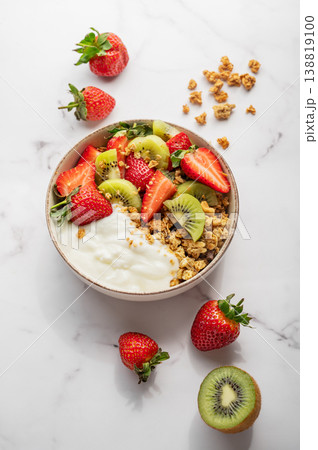 Healthy yogurt bowl with granola and fresh berries for clean eating diet 138819100