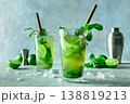Mojito, summer cocktail with mint, lime, and ice, side view of two glasses 138819213