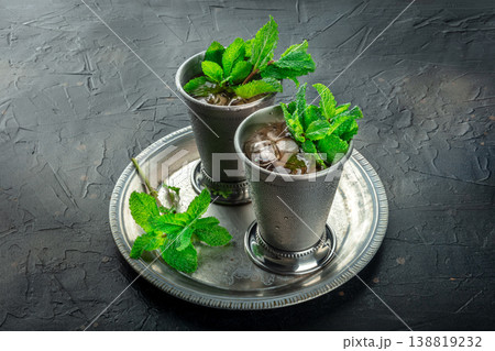 Mint Julep in the Kentucky Derby classic silver glass, with fresh mint leaves 138819232