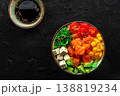 Salmon poke bowl with mango, avocado, tofu, wakame, overhead shot 138819234