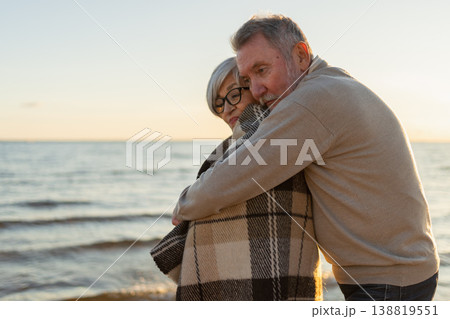 Senior mature couple hugging enjoying outdoor recreation walking on beach. Old husband wife embracing with tenderness love enjoying sweet bonding. Grandmother grandfather together. Family moment love Senior mature couple hugging enjoying outdoor recreation walking on beach. Old husband wife embracing with tenderness love enjoying sweet bonding. Grandmother grandfather together. Family moment love 138819551