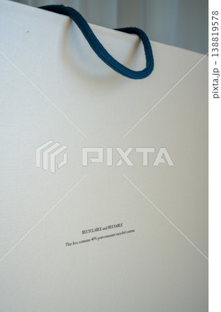 Close up of recyclable and reusable packaging label on eco friendly box with copy space. Sustainable materials and environmental responsibility concept. Close up of recyclable and reusable packaging label on eco friendly box with copy space. Sustainable materials and environmental responsibility concept. 138819578