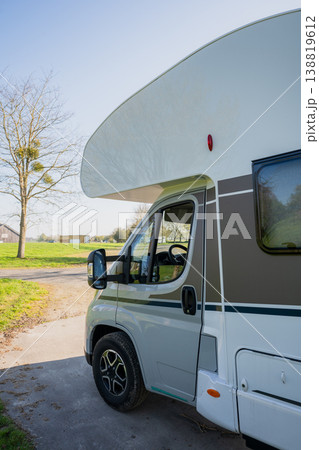 Modern campervan parked on rural road with green field and spring landscape in sunny countryside travel scene Modern campervan parked on rural road with green field and spring landscape in sunny countryside travel scene 138819612