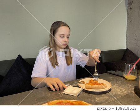 Cute child 10 years old. Young girl eating pizza in italian cafe Cute child 10 years old. Young girl eating pizza in italian cafe 138819615