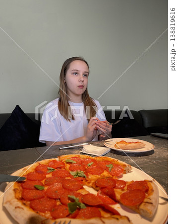 Portrait of child 10 years old. Young girl eating pizza in italian cafe Portrait of child 10 years old. Young girl eating pizza in italian cafe 138819616