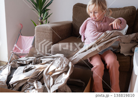 Excited 4 year old girl unboxing a huge delivery parcel at home 138819810