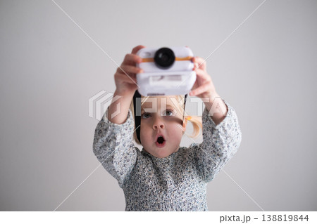 Curious 4 year old girl capturing creative moments with her first toy digital camera at home 138819844