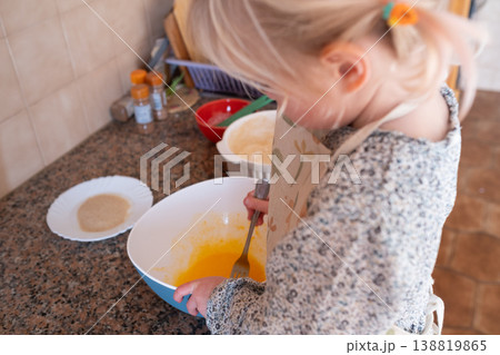 Independent preschooler: little 4 year old girl baking a homemade pie alone in a cozy kitchen 138819865
