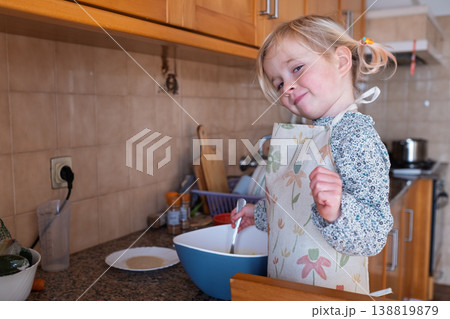 Independent preschooler: little 4 year old girl baking a homemade pie alone in a cozy kitchen Independent preschooler: little 4 year old girl baking a homemade pie alone in a cozy kitchen 138819879