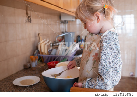 Independent preschooler: little 4 year old girl baking a homemade pie alone in a cozy kitchen Independent preschooler: little 4 year old girl baking a homemade pie alone in a cozy kitchen 138819880