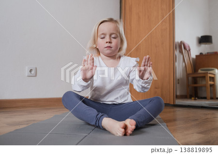 Calm child practicing mindfulness and deep breathing at home Calm child practicing mindfulness and deep breathing at home 138819895