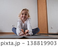 Little girl practicing yoga in Butterfly pose Baddha Konasana at home. 138819903