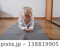 Cute preschooler lying on the floor and smiling before yoga practice. 138819905