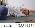 Little girl practicing yoga, lying in Savasana Corpse Pose on a mat. 138819934